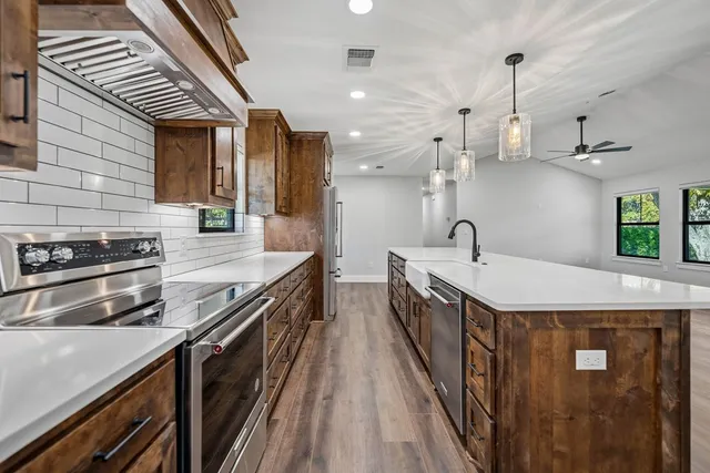a kitchen with stainless steel appliances a sink and stove