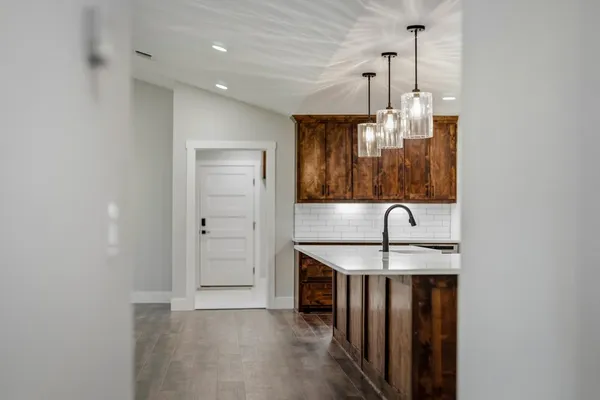 a kitchen with stainless steel appliances granite countertop a sink and a refrigerator