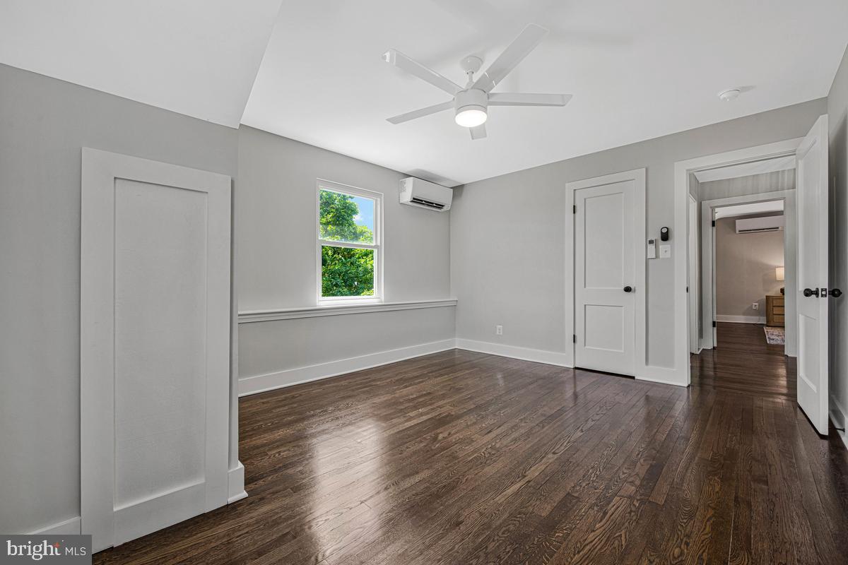2105 Queens Chapel Road Mount Rainier, MD 20712 - Photo 15 of 33 an empty room with wooden floor and windows