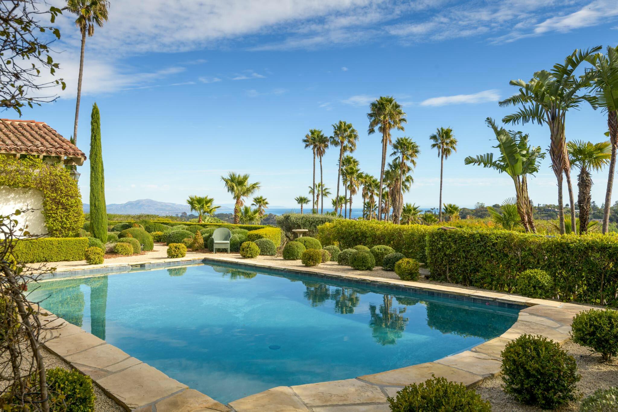 272 El Cielito Road Santa Barbara, CA 93103 - Photo 1 of 24 a view of a swimming pool with a lawn chairs under an umbrella