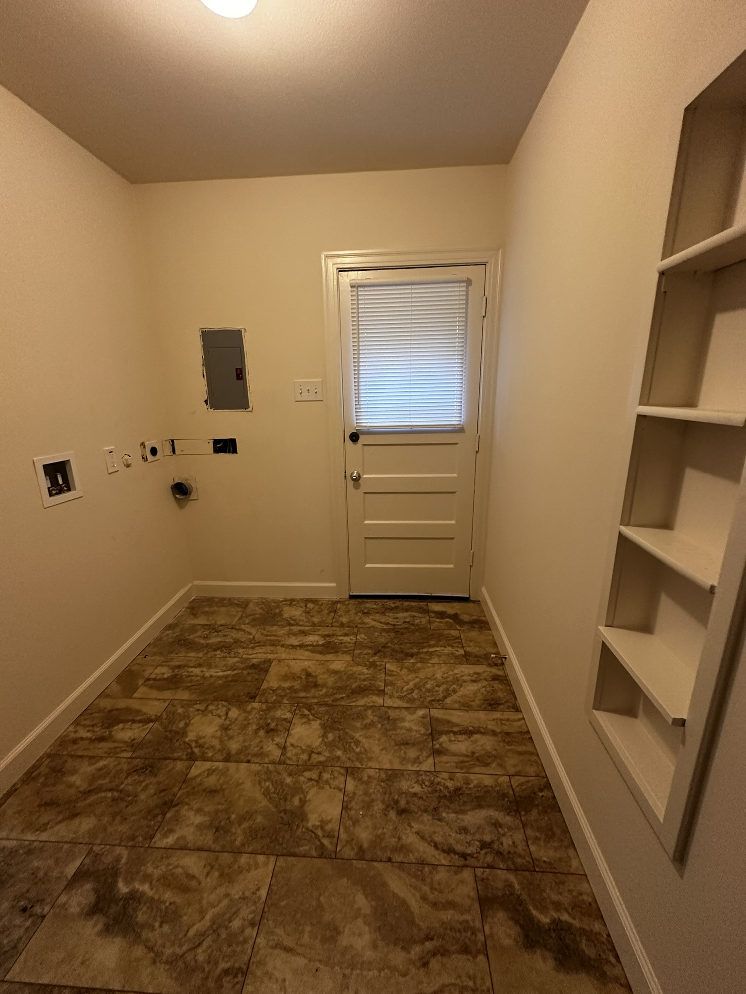 3903 Ridgelea Drive Austin, TX 78731 - Photo 10 of 17 Tiled flooring and built-in shelving define this practical utility space with exterior access.