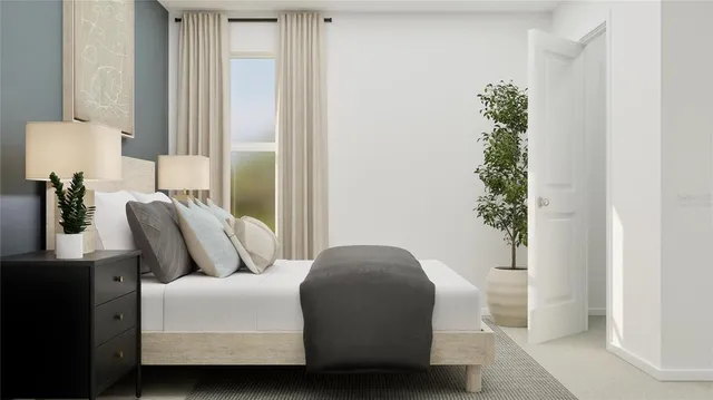 a bedroom with furniture and a potted plant