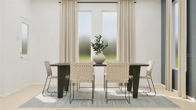 a dining room with furniture and a potted plant