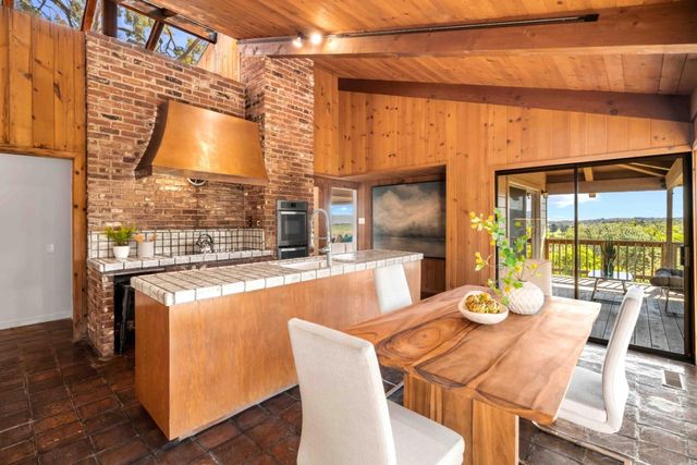 a dining room with furniture a chandelier and wooden floor