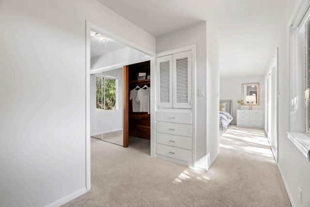 an empty room with closet and mirror