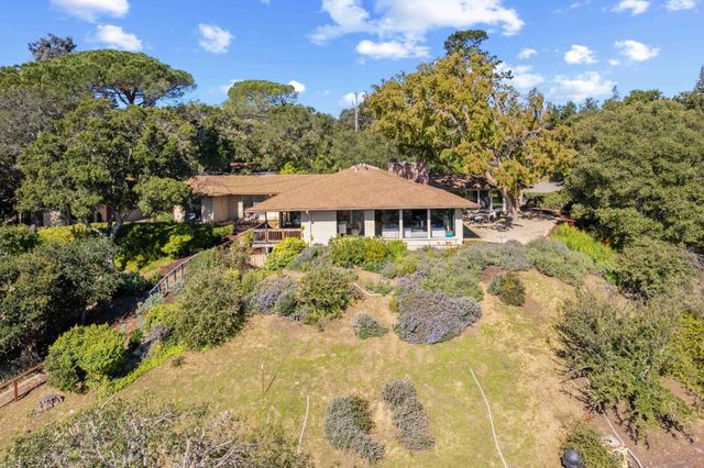 a view of a house with a yard and garden