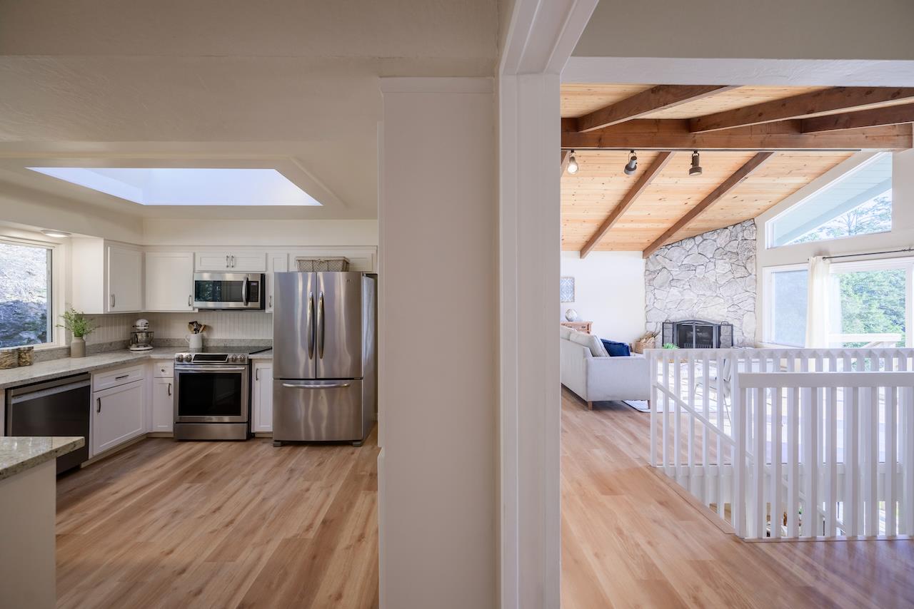 155 Rabbits Run Road Santa Cruz, CA 95060 - Photo 42 of 113 a kitchen with stainless steel appliances granite countertop a refrigerator a sink dishwasher a stove and white countertops with wooden floor