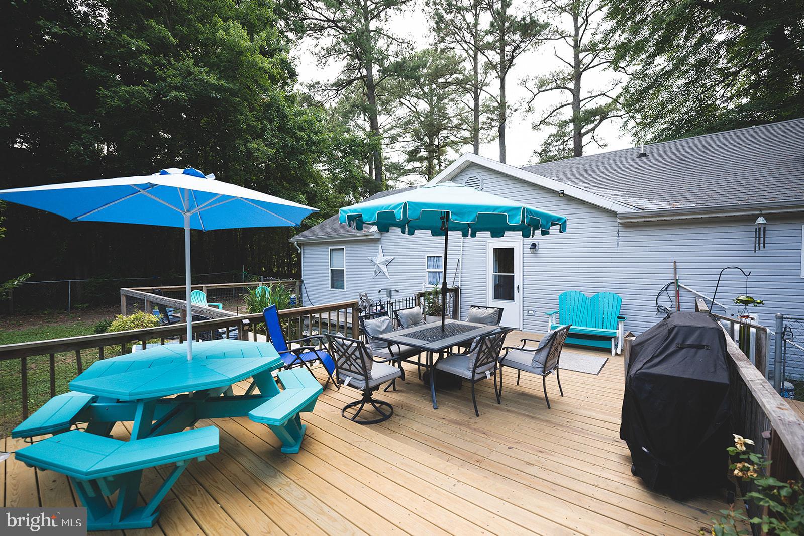 21831 Wetipquin Road Quantico, MD 21856 - Photo 47 of 57 a view of a chairs and table under an umbrella in patio
