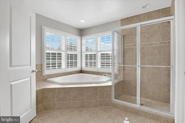 a bathroom with a tub and shower