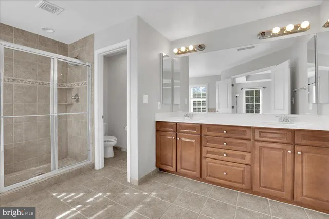 a spacious bathroom with a granite countertop sink mirror and a