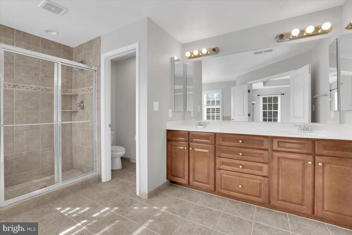 41625 Broxbourne Terrace Aldie, VA 20105 - Photo 17 of 43 a spacious bathroom with a granite countertop sink mirror and a