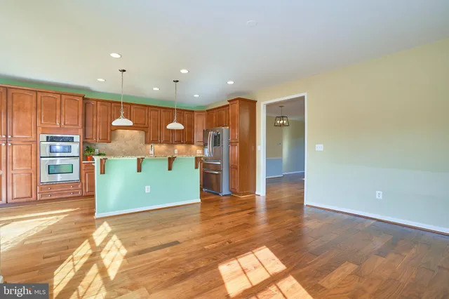 a room with wooden floors and large windows