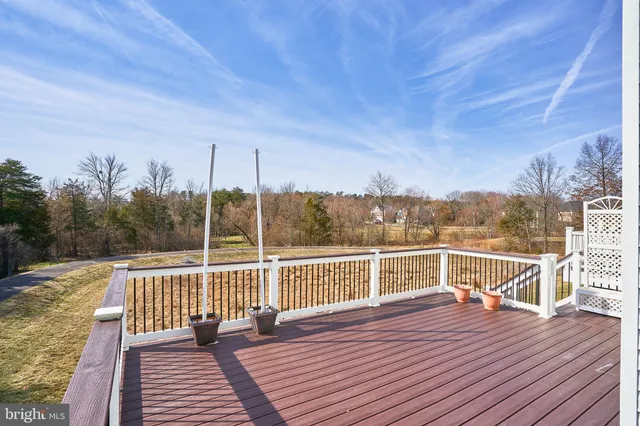 a view of a roof deck with couches and wooden floor
