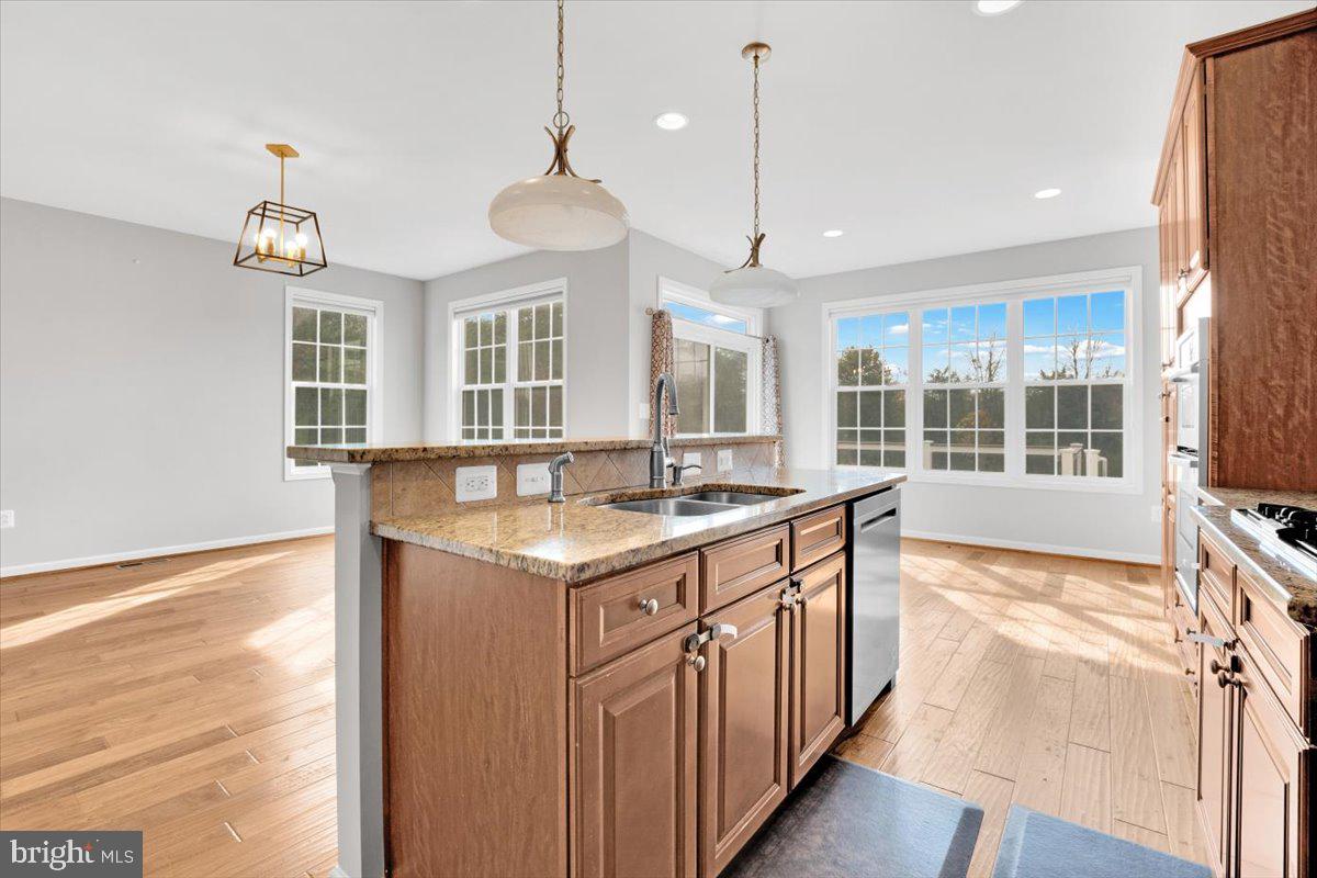 41625 Broxbourne Terrace Aldie, VA 20105 - Photo 25 of 43 a kitchen with a sink stove and wooden floor