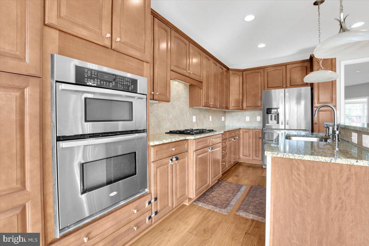 41625 Broxbourne Terrace Aldie, VA 20105 - Photo 27 of 43 a kitchen with stainless steel appliances granite countertop a stove a sink and a microwave