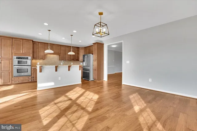 a view of kitchen with kitchen island a sink appliances and a counter top space