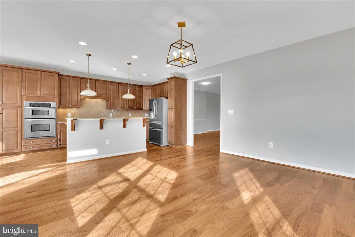 41625 Broxbourne Terrace Aldie, VA 20105 - Photo 30 of 43 a view of kitchen with kitchen island a sink appliances and a counter top space