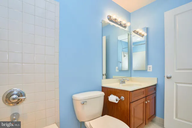 a bathroom with a sink mirror vanity and toilet