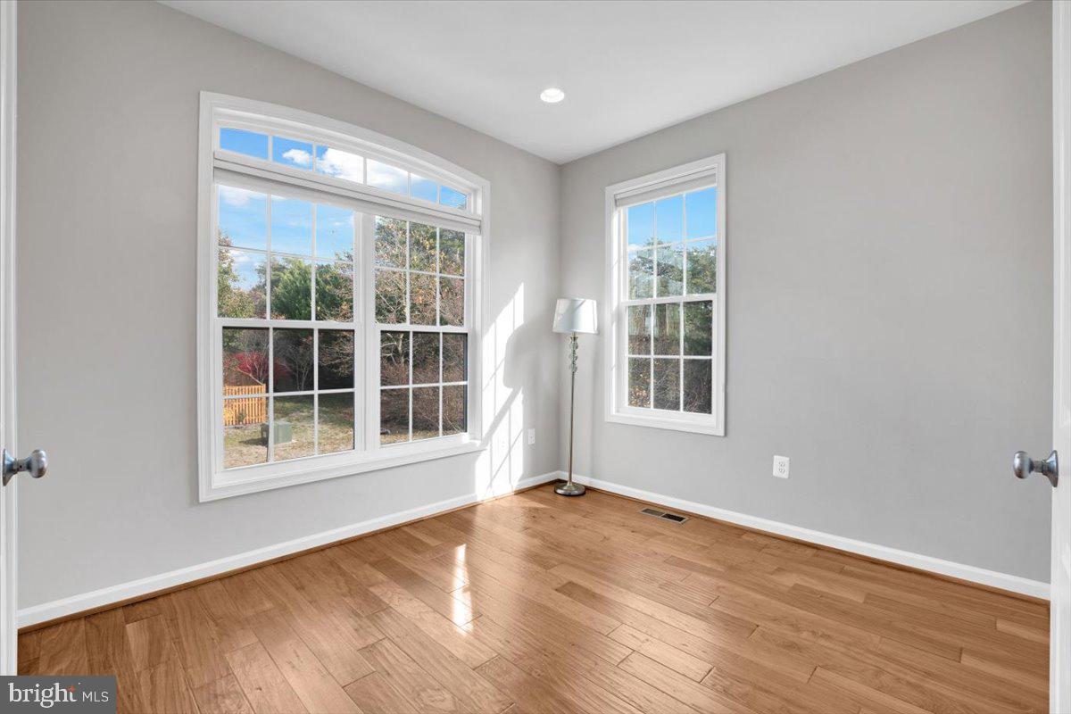 41625 Broxbourne Terrace Aldie, VA 20105 - Photo 36 of 43 a view of an empty room with a window and wooden floor