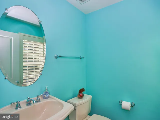 a bathroom with a sink mirror and toilet