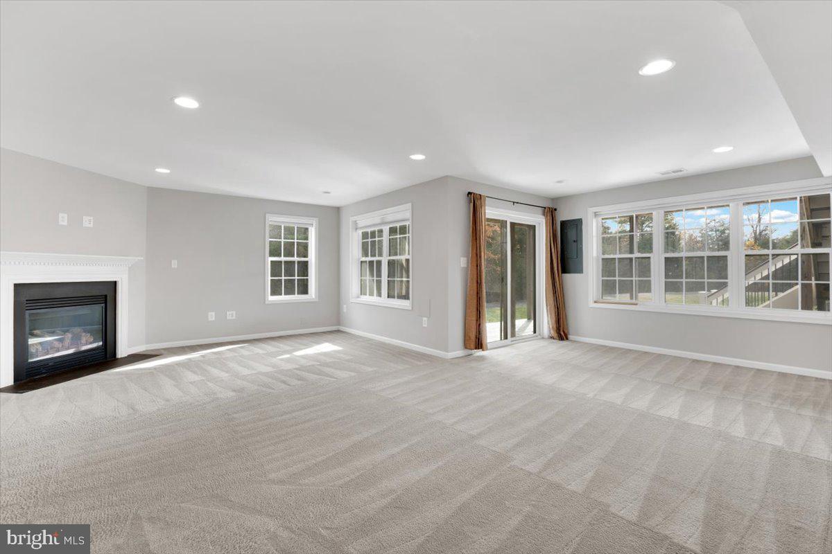 41625 Broxbourne Terrace Aldie, VA 20105 - Photo 7 of 43 a view of an empty room with a window and fireplace