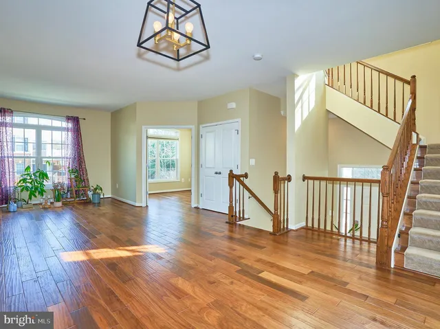a view of entryway with wooden floor and front door