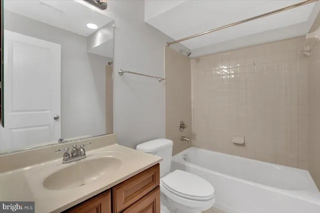 a bathroom with a sink toilet vanity and shower