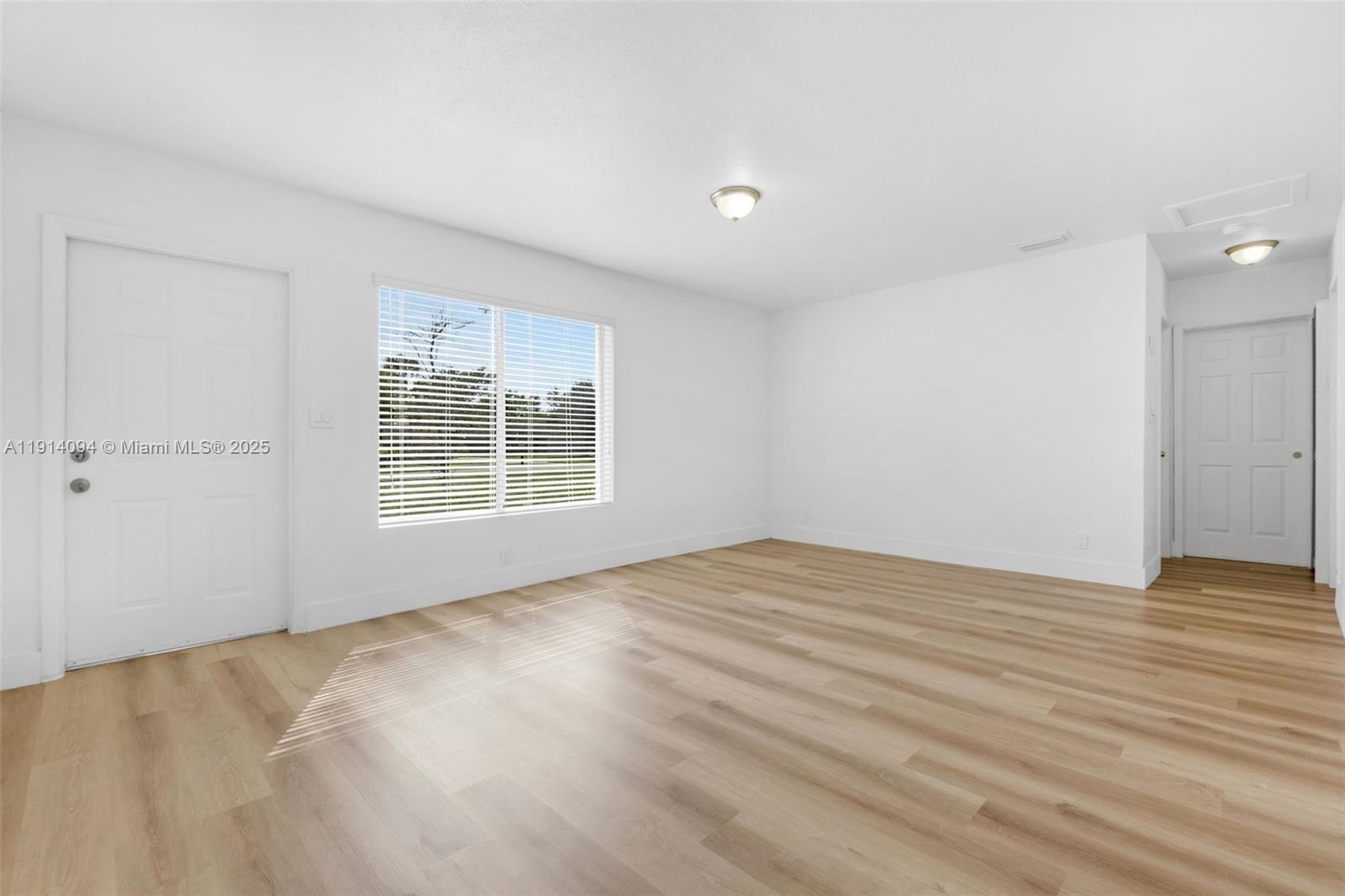 5713 Seton Drive Margate, FL 33063 - Photo 15 of 33 a view of an empty room with wooden floor and a window