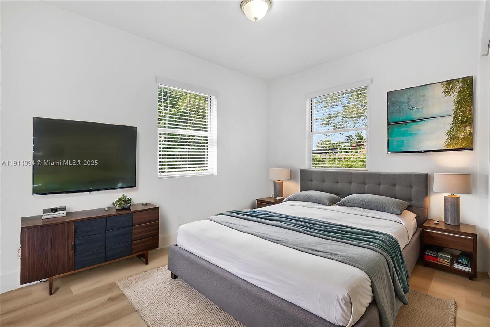 5713 Seton Drive Margate, FL 33063 - Photo 26 of 33 a bedroom with a bed and a flat screen tv