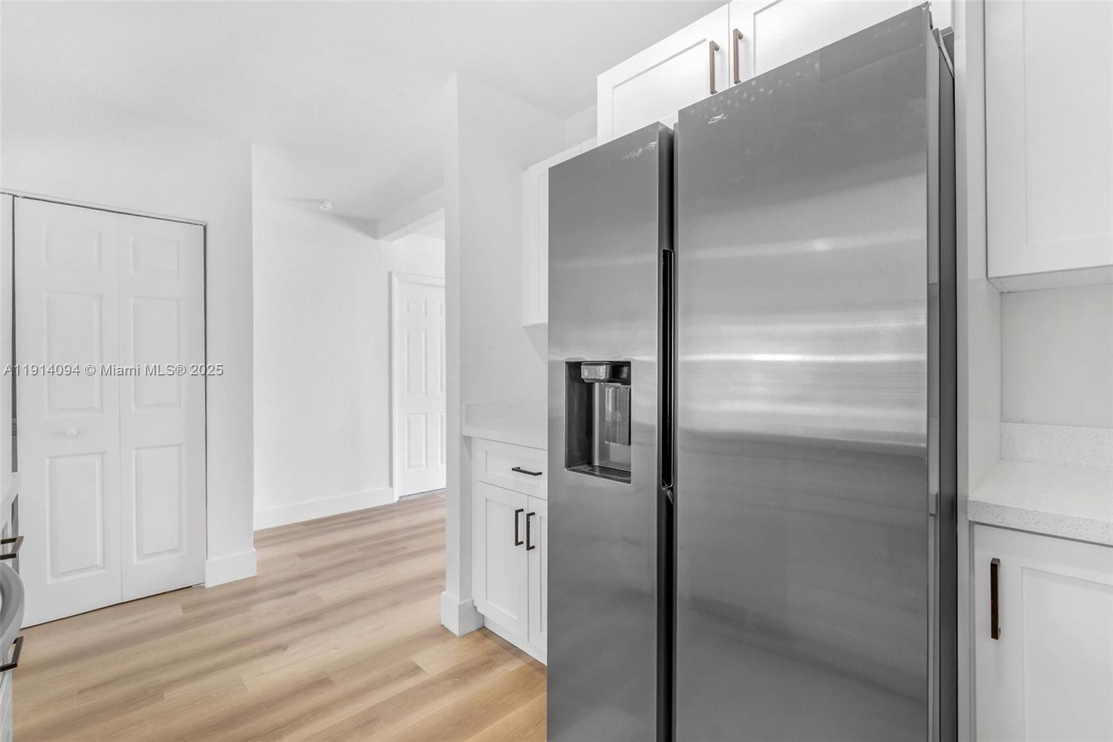 5713 Seton Drive Margate, FL 33063 - Photo 5 of 33 a kitchen with a refrigerator and wooden floor