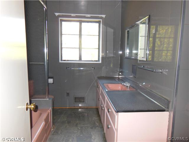 8010 Cameron Road Richmond, VA 23229 - Photo 11 of 14 a bathroom with a granite countertop sink and a large mirror