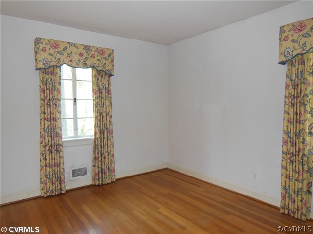8010 Cameron Road Richmond, VA 23229 - Photo 12 of 14 an empty room with wooden floor and windows