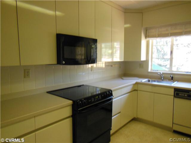 8010 Cameron Road Richmond, VA 23229 - Photo 7 of 14 a kitchen with a sink a stove and cabinets