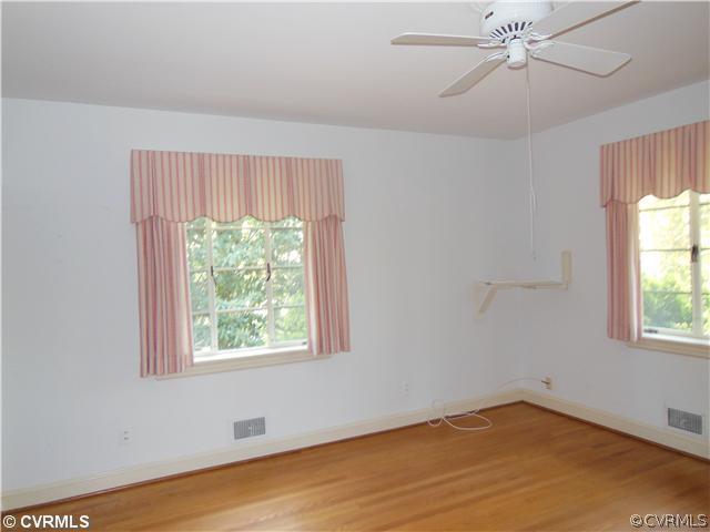 8010 Cameron Road Richmond, VA 23229 - Photo 10 of 14 an empty room with a window and a ceiling fan