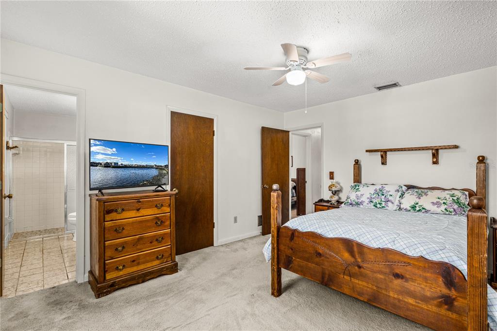 693 Reillys Road Port Orange, FL 32127 - Photo 19 of 31 a bedroom with a bed and a ceiling fan