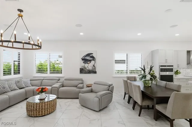 a kitchen with granite countertop a counter space dining table and stainless steel appliances