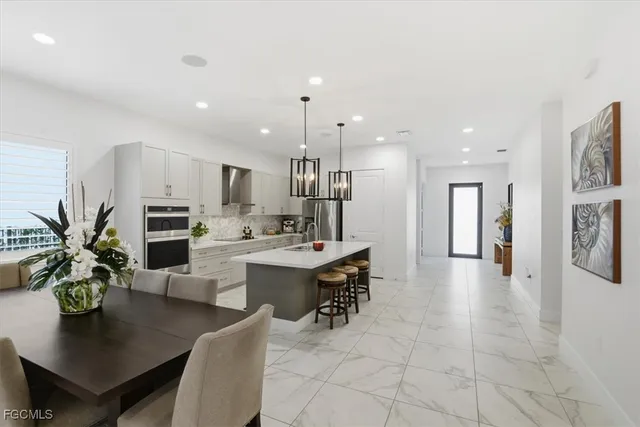 a kitchen with stainless steel appliances granite countertop a sink refrigerator and microwave