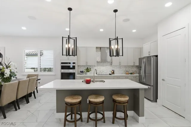 a kitchen with stainless steel appliances a sink and a refrigerator