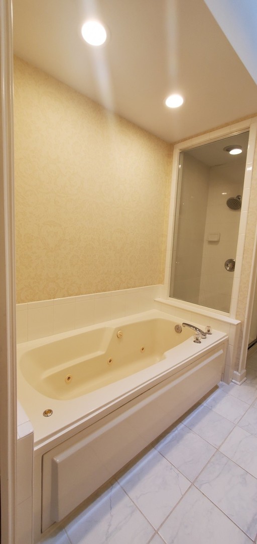 536 West Evergreen Street Wheaton, IL 60187 - Photo 18 of 27 a bathroom with a bathtub and a shower