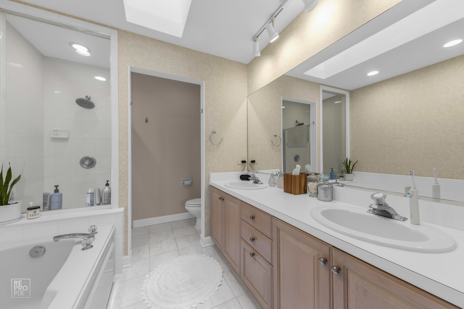 536 West Evergreen Street Wheaton, IL 60187 - Photo 19 of 27 a spacious bathroom with a double vanity sink mirror double and shower