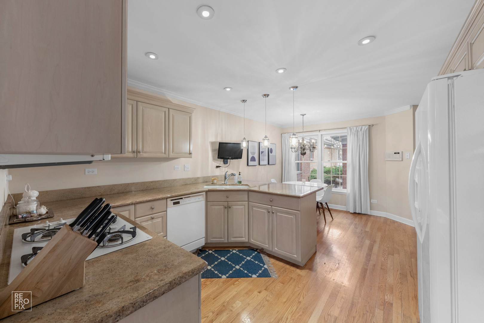 536 West Evergreen Street Wheaton, IL 60187 - Photo 2 of 27 a kitchen with granite countertop a sink stove and refrigerator