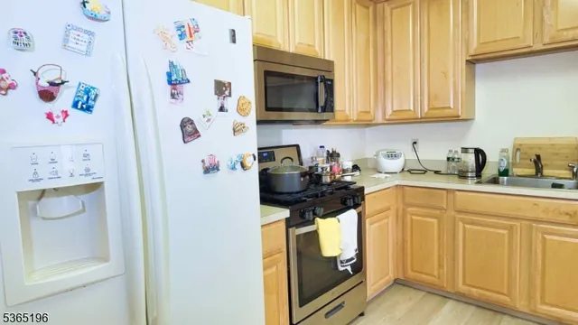 a kitchen with stainless steel appliances granite countertop a refrigerator and cabinets