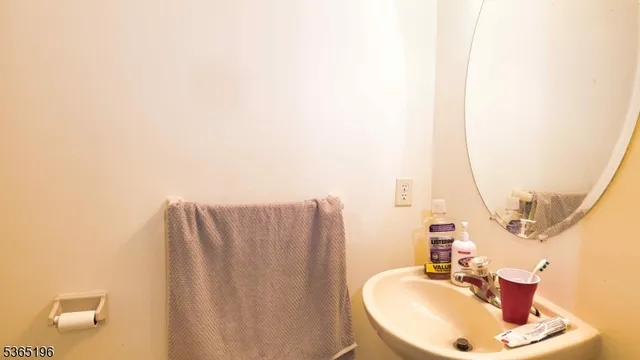 a bathroom with a sink a mirror and vanity