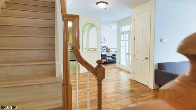 a view of an entryway with wooden floor and a livingroom view