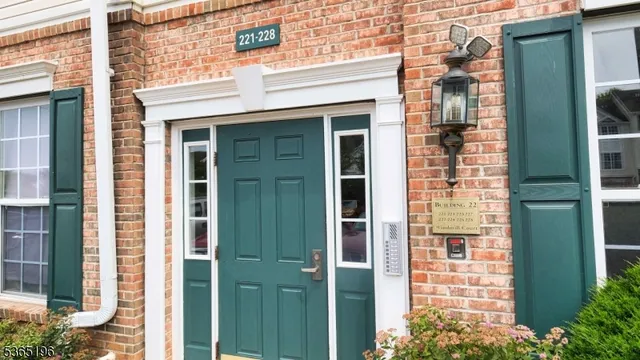 front door of a brick house with a large windows