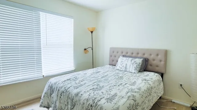 a large bed sitting in a bedroom next to a window