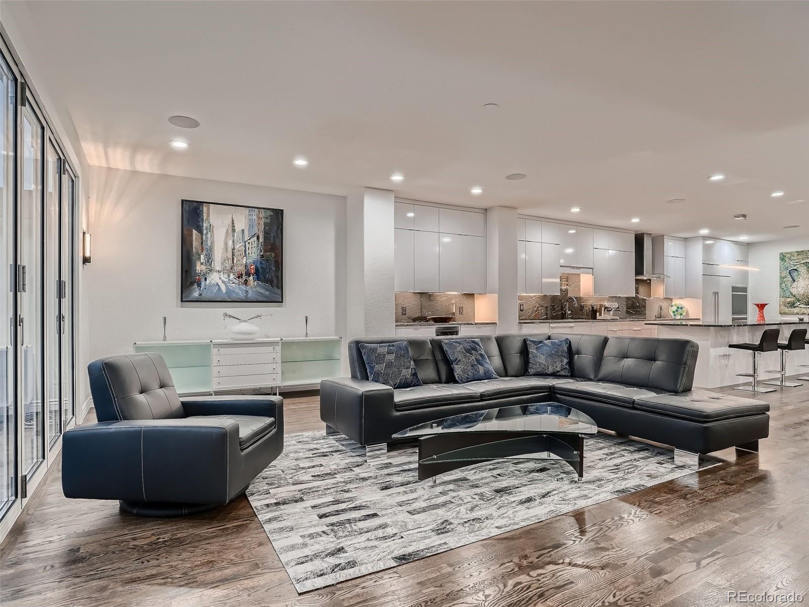 338 St Paul Street Denver, CO 80206 - Photo 12 of 40 a living room with furniture wooden floor and kitchen view