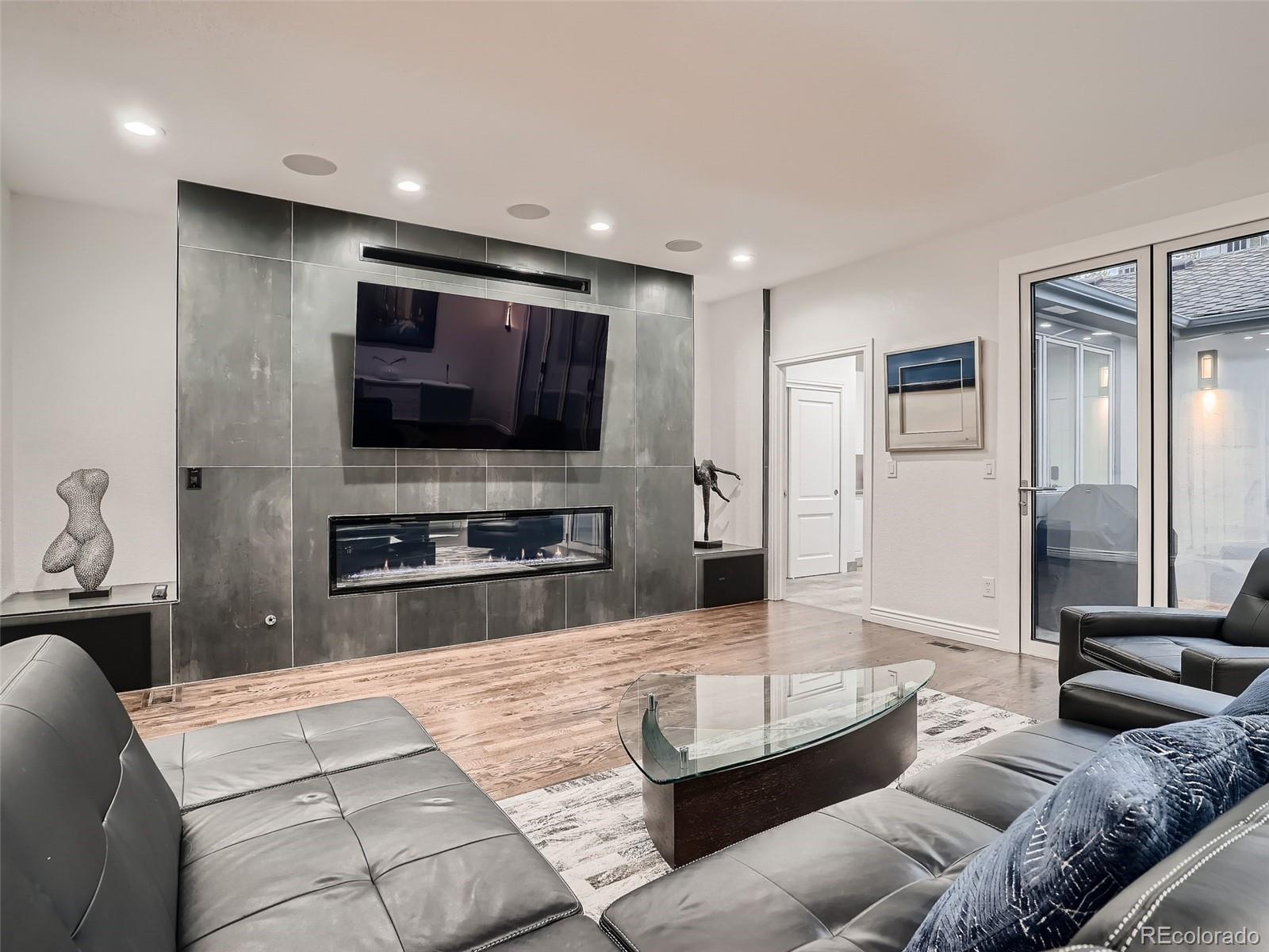 338 St Paul Street Denver, CO 80206 - Photo 14 of 40 a living room with furniture and a flat screen tv