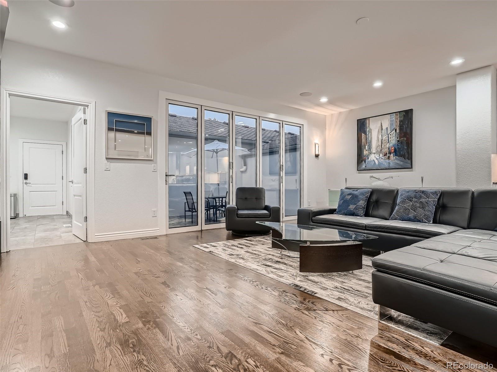338 St Paul Street Denver, CO 80206 - Photo 16 of 40 a living room with furniture and kitchen view