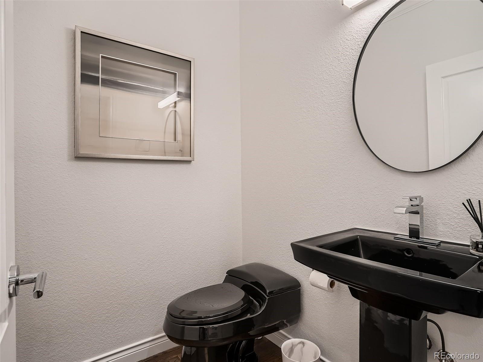 338 St Paul Street Denver, CO 80206 - Photo 19 of 40 a bathroom with a sink a mirror and a toilet